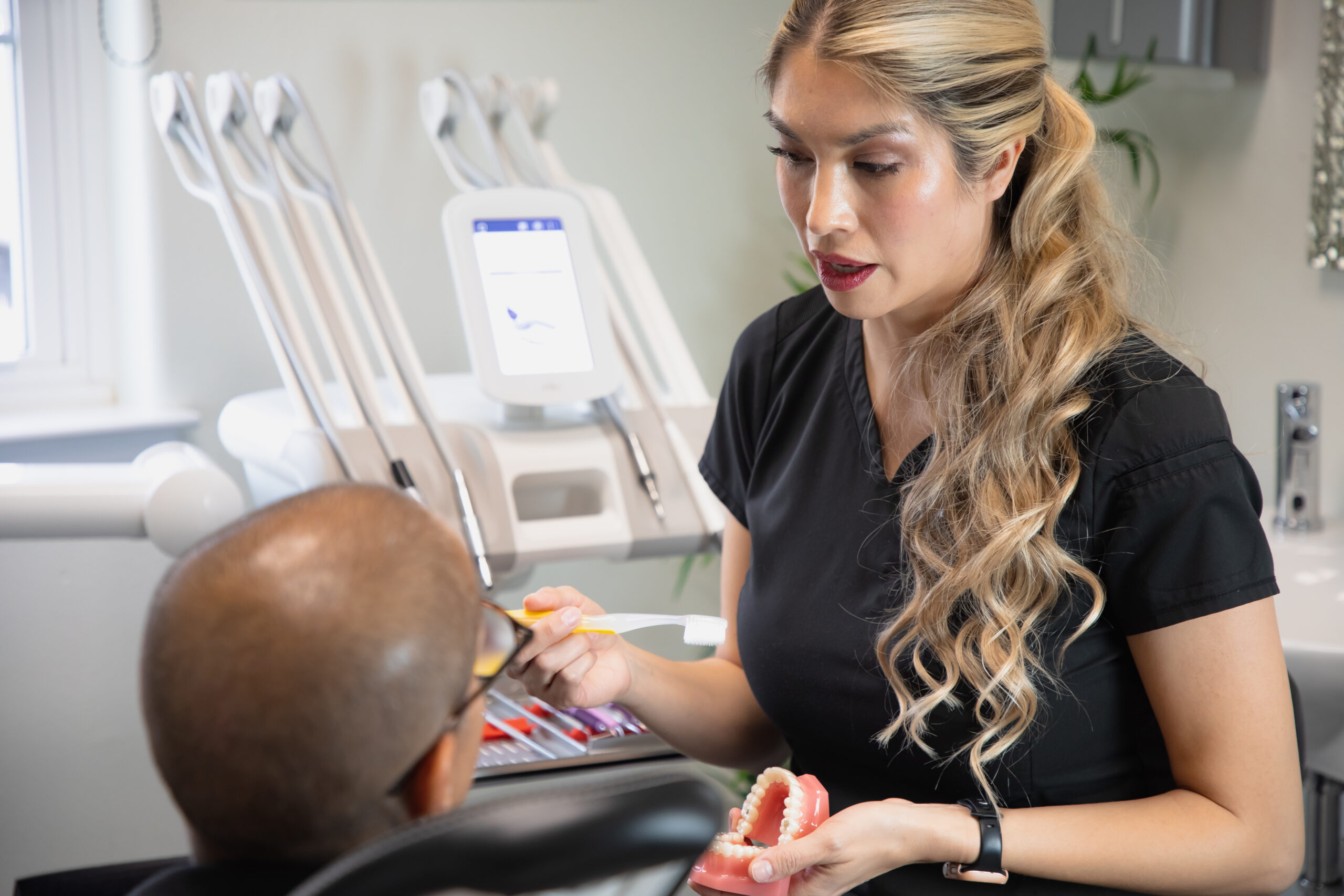 Milagro Dental hygienist demonstrating toothbrushing in Santa Fe, NM clinic